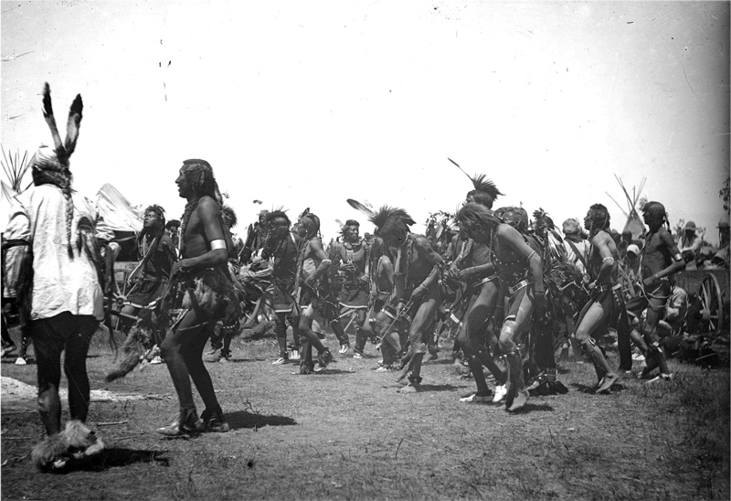 A large group of Salish danceers in loincloths