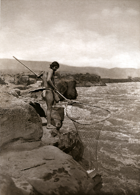 Historic photo of an almost naked indians fishing in the wild Columbia River before dams