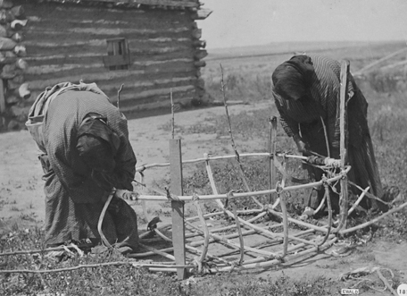 Indian women building a bull boat