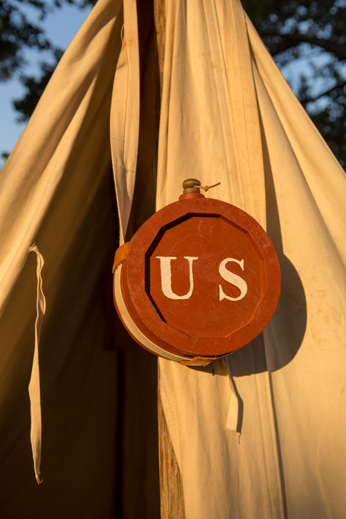 Wood canteen, painted red with 'US' logo in white