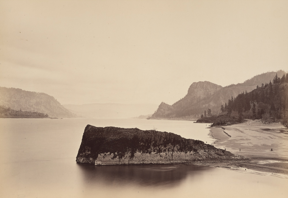 Early photo of black rocks jutting into the river