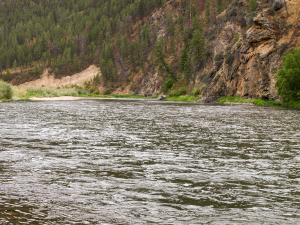 Rapid river clings to rock cliffs
