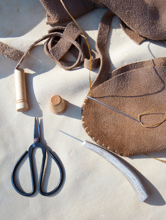 Mocassins, scissors, needle, sinew thread, and awl