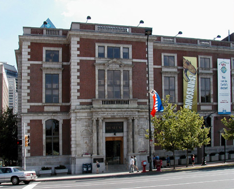 Three-story brick building with small Roman columns