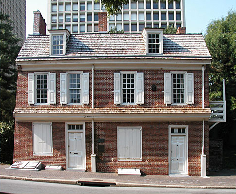 Two and a half-story brick building with attice dormers