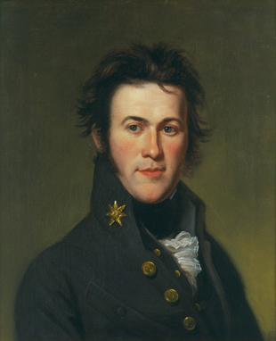 A young man with navy blue jacket with a high collar