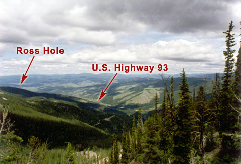 Looking down into a narrow, forested valley