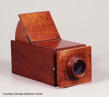 wooden box with lens that looks like an old view camera