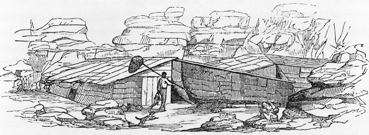 large, rectangular buildings surrounded by cliffs