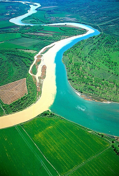 Aerial view of the muddy Milk River entering the blue Missouri River