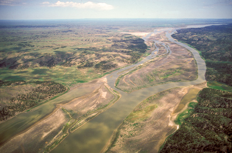 Aerial view of a braided channel river winding through islands