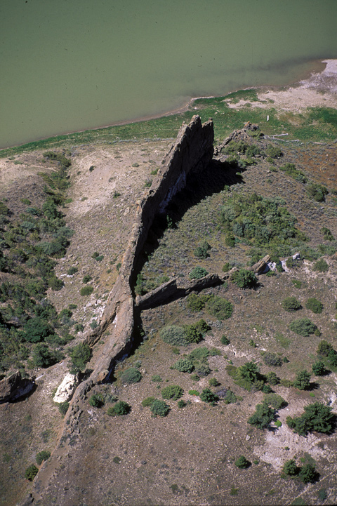 Aerial view of Grant Natural Wall, a tall, skinny rock jutting above the river