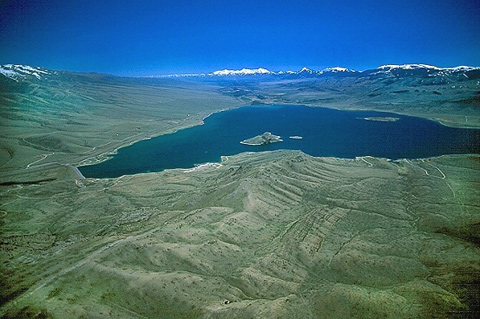 triangular reservoir of water surrounded by hills and mountains