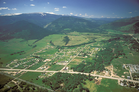 aerial view of a green valley with a small city