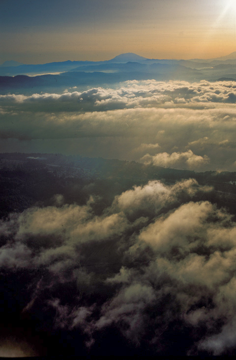 Aerial photo showing the snow peaks above the clouds