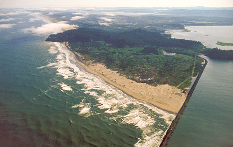 interactive aerial photo showing the triangular spit of land formed by the Columbia River entering the ocean behind a levy