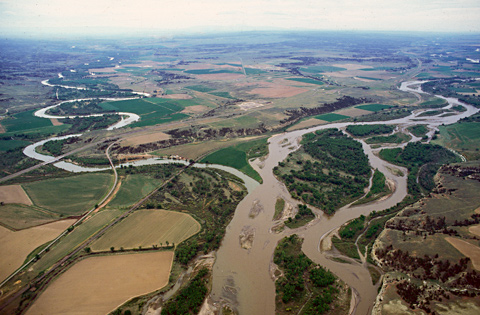 Aerial photo showing the small Pryor Creek entering the Yellowstone river which is clogged with islands