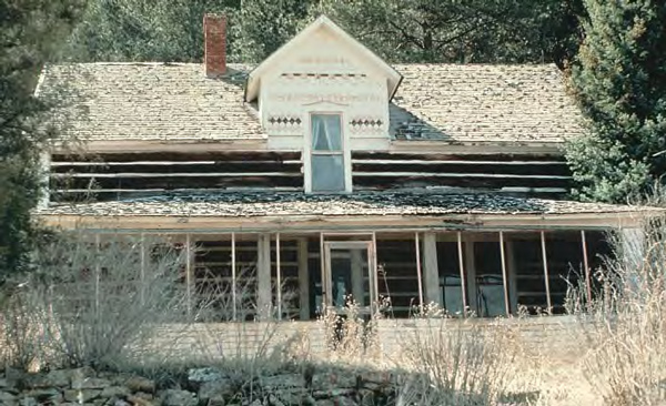 Large log house with dormer and covered porch