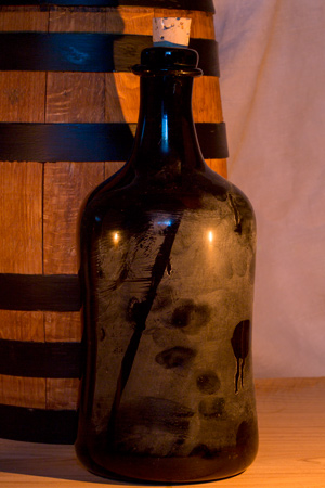 A small wooden keg and old dark bottle