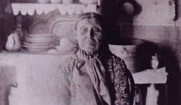 Maggie Adams, an old PNW Coast Native American, in a house