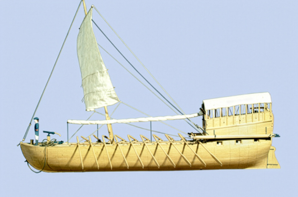 scale model of a wooden, masted boat