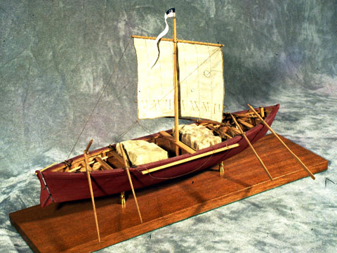 large rowboat with a sail