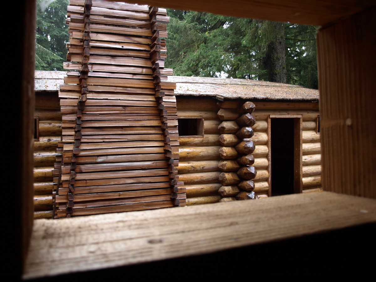 Looking out a cabin window at a line of other cabins
