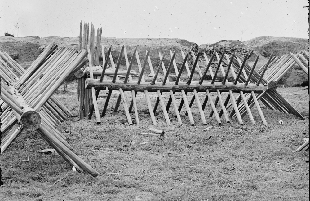 A breast-work of spikes protruding from a single, horizontal log