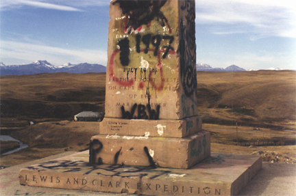 The original text on a Lewis and Clark marker covered with spray painted graffiti