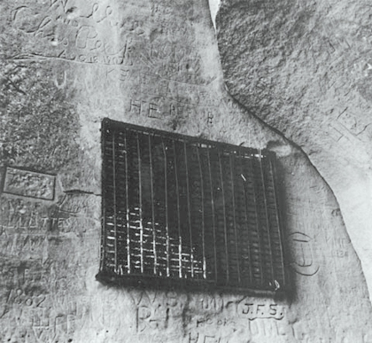 Rock face with a heavy iron grill covering Clark's signature