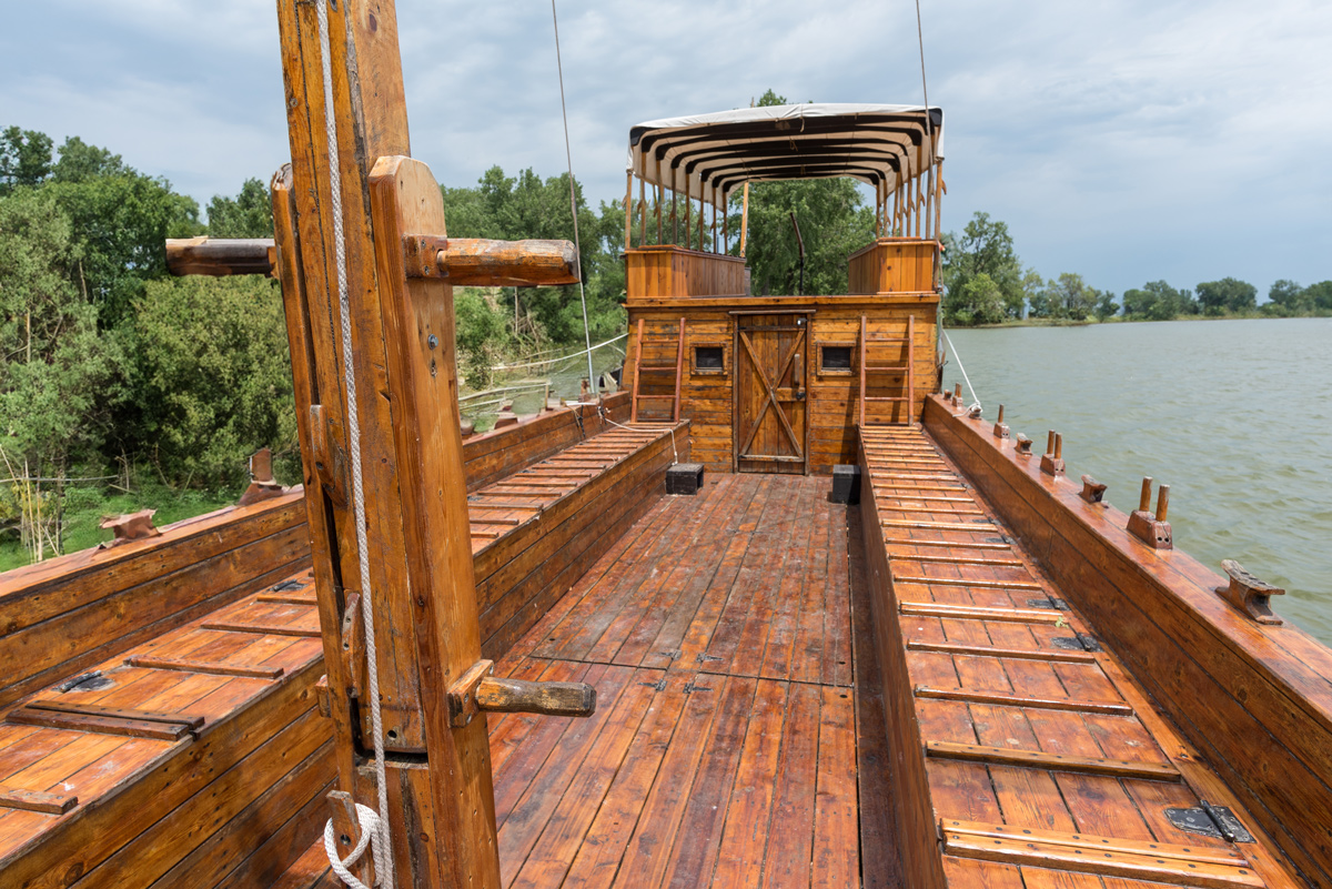 Back of a wood boat with a canvas roof