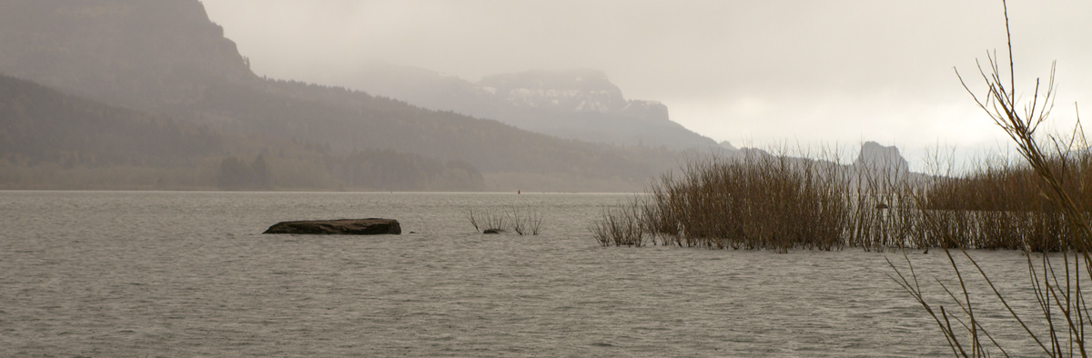 Waves, rain, and dark cloud sweep down the river