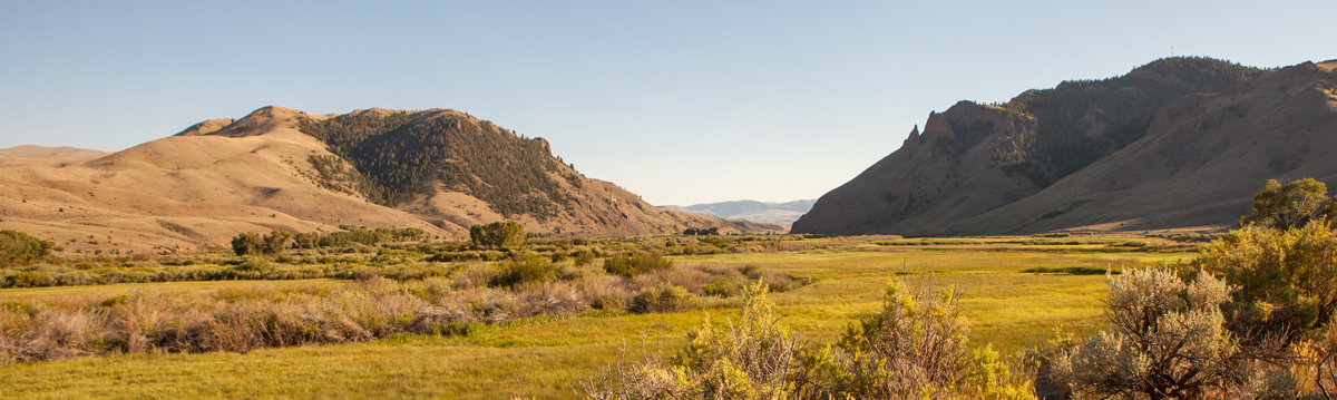 River flows between two high ridges
