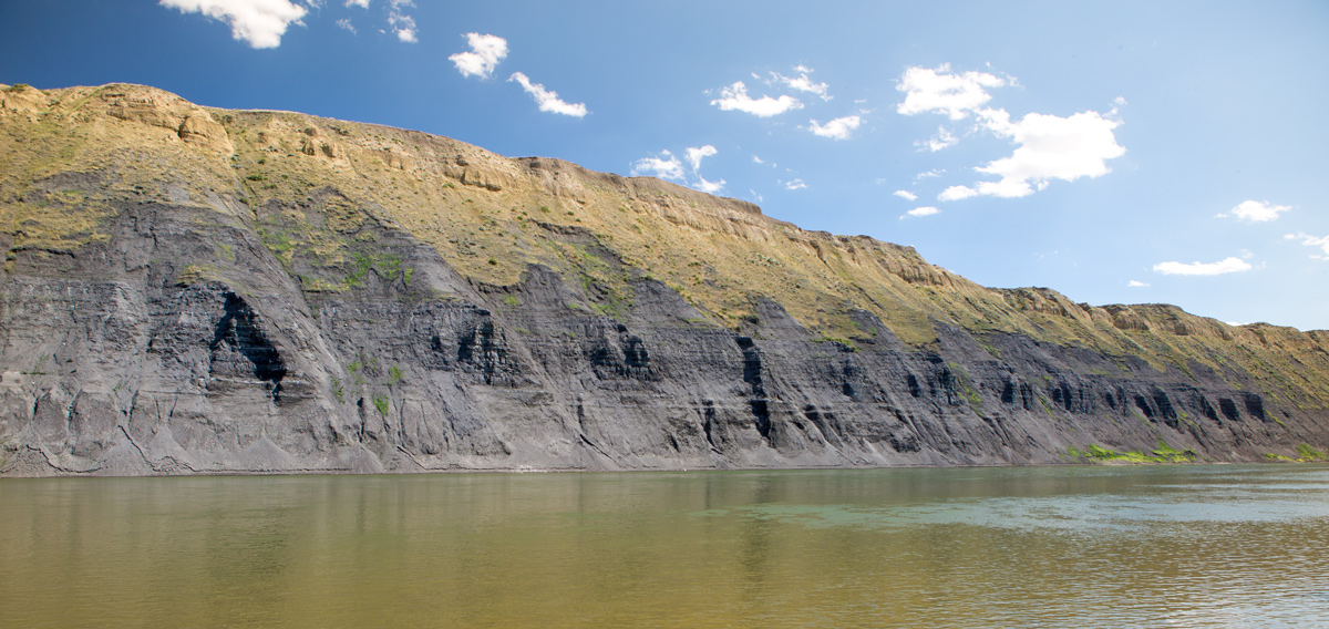 Black cliffs topped by yellow soil