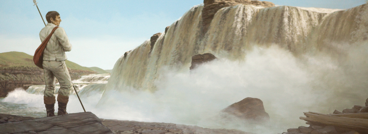 Lewis stands to the side of a wide waterfall
