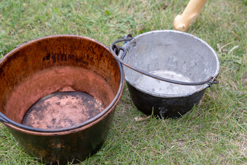 Large and small kettle blackened by fires