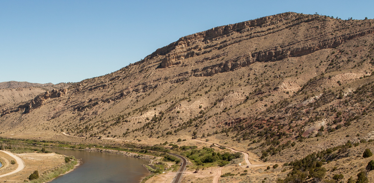 Sagebrush hills with layers of sloping rock