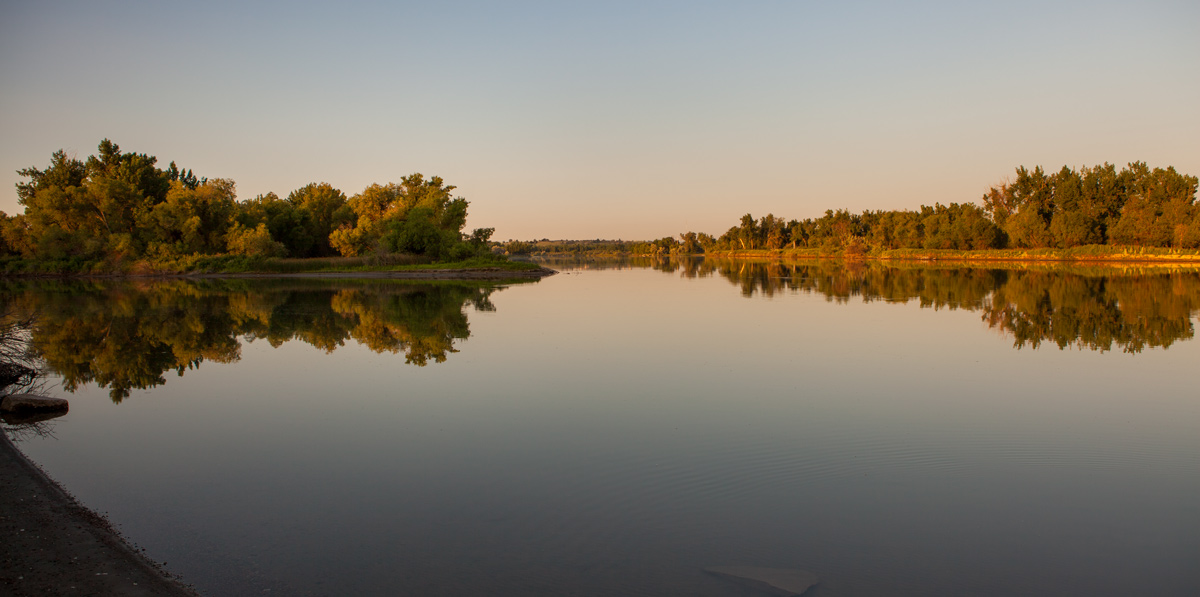 Early morning lights on a perfectly still river