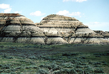 round hills with layers of tan and black rock