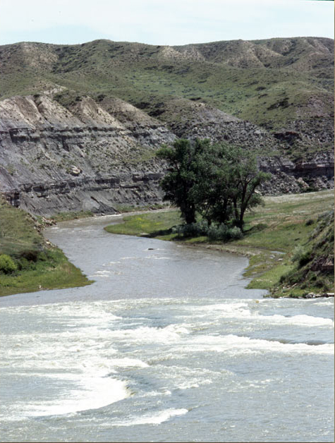 large creek entering the Missouri River at a rapid