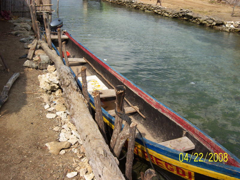 large dugout canoe painted yellow, red, and blue