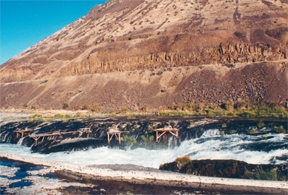 Wooden Indian fishing platforms above a waterfall
